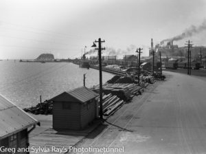 Looking east across the timber wharf, Newcastle Harbour. Circa 1930s.