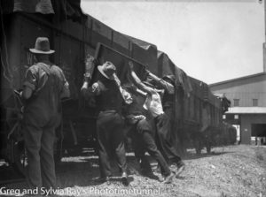 Workers at the side of railway wheat trucks at Newcastle’s grain silos, December 5, 1938.