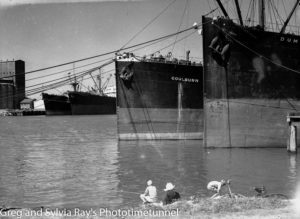 Boys fishing near ships tied at the “dolphins”, Newcastle Harbour, January 20, 1949.