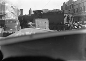 View from a car waiting for a coal train to cross Hunter Street Newcastle, NSW, at Burwood Street. August 10, 1939.