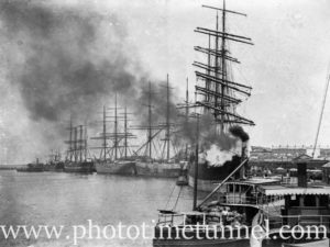 Sailing ships seen through a cloud of smoke from a steam boat on Newcastle Harbour, NSW, circa 1910.