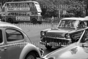“Mother! Only Ovaltine”: Bus and Holden car near Carrington Street, Sydney, circa 1960s.