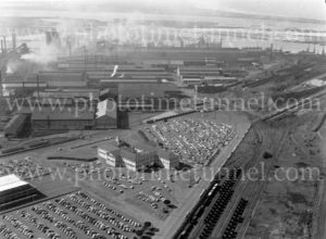 Aerial view of the BHP steelworks, Newcastle, NSW, showing the administration building and carpark, 1960s.