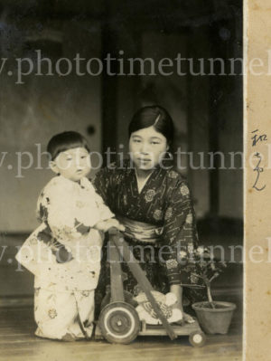 Japanese woman and child with wheeled toy, circa 1936.