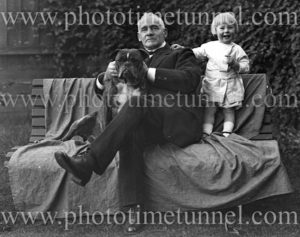 Elderly man with dog and young child, circa 1910.