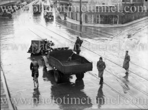 Traffic on a rainy day at Bank Corner, Hunter Street, Newcastle, NSW. May 6, 1939.