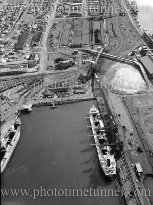Aerial view of The Basin coal loader and part of Carrington, Newcastle, NSW, June 1983