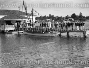 Season opening for Lake Macquarie Yacht Club, October 19, 1935. Scene shows clubhouse and crowd on jetty. (3)