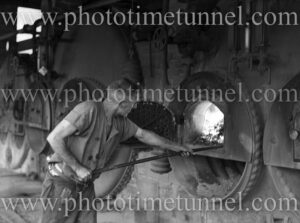 Stoking a furnace at Dudley Colliery, near Newcastle, NSW, March 27, 1939